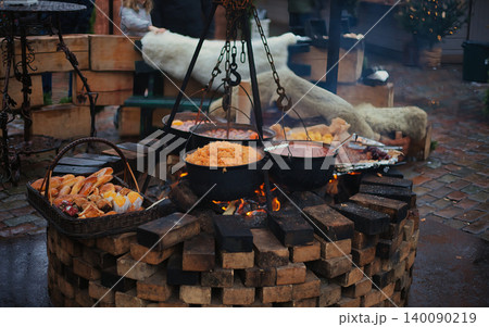 Outdoor brick fire pit at a festive market with hanging  140090219