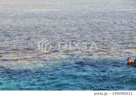 Tropical Sea with Boat and Snorkelers in Clear Shallow Water Tropical Sea with Boat and Snorkelers in Clear Shallow Water 140090831