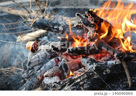 Roasting food and marshmallow over a campfire 140090869