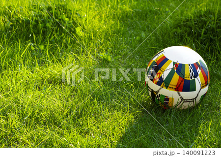 Soccer ball on a green grass field, representing outdoor sports equipment on grass and a bright summer sports atmosphere. Soccer ball on a green grass field, representing outdoor sports equipment on grass and a bright summer sports atmosphere. 140091223