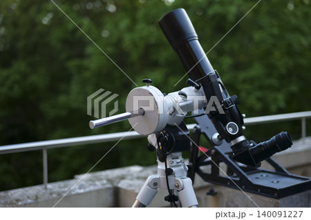 Astronomy telescope on a tripod, reflecting astronomy as a modern hobby, lifestyle activity and engaging night sky exploration. Astronomy telescope on a tripod, reflecting astronomy as a modern hobby, lifestyle activity and engaging night sky exploration. 140091227