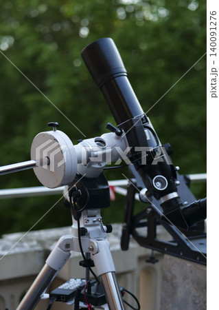 Astronomy telescope on a tripod, emphasizing mechanical craftsmanship and precision engineering in astronomical instruments. Astronomy telescope on a tripod, emphasizing mechanical craftsmanship and precision engineering in astronomical instruments. 140091276