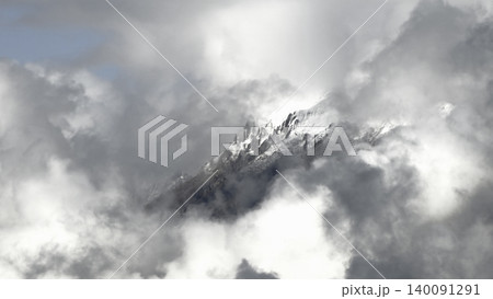 A snow capped mountain peak emerges from the clouds in the Austrian Alps, creating a spectacular picture of fog and light. A snow capped mountain peak emerges from the clouds in the Austrian Alps, creating a spectacular picture of fog and light. 140091291