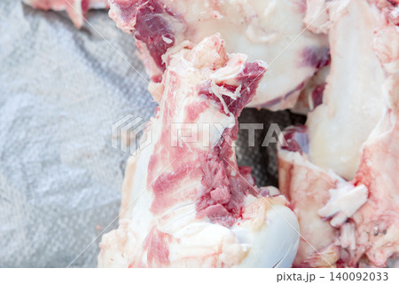 Fresh raw pork ribs cut into pieces on a textured surface Fresh raw pork ribs cut into pieces on a textured surface 140092033