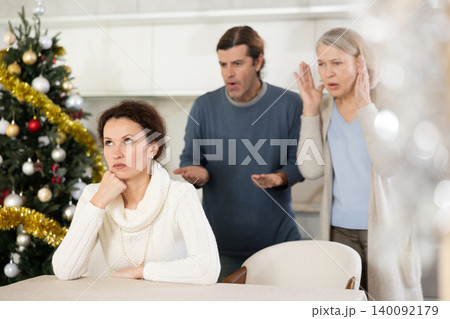Man and mature mom yell to woman on Christmas Eve Man and mature mom yell to woman on Christmas Eve 140092179