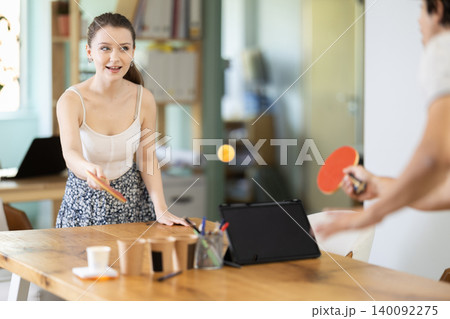 Active office employees playing ping pong Active office employees playing ping pong 140092275