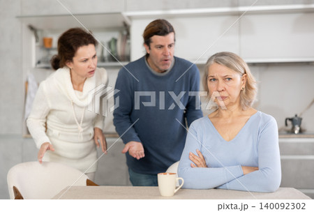 Adult children man and woman clashed with elderly mother. Adult children man and woman clashed with elderly mother. 140092302