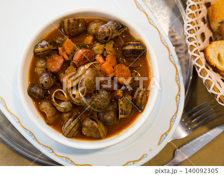 Top view of snails stewed with chorizo Top view of snails stewed with chorizo 140092305
