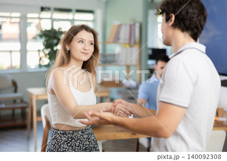 Young man shaking hands with girl in office 140092308