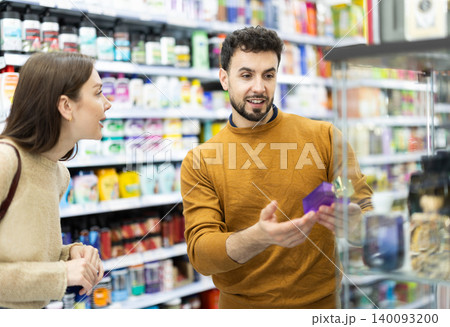 Couple spends time in store, looking for goods and select perfume Couple spends time in store, looking for goods and select perfume 140093200