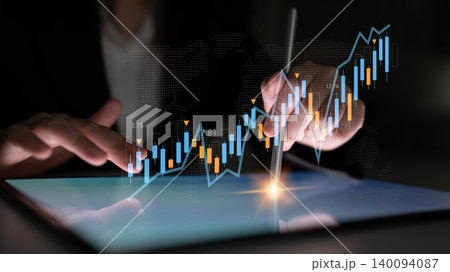 Business professional analyzing financial data on digital tablet with glowing charts and graphs, demonstrating market trends and investment strategies Gantry Business professional analyzing financial data on digital tablet with glowing charts and graphs, demonstrating market trends and investment strategies Gantry 140094087