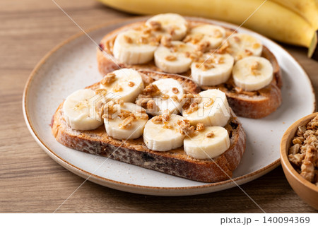 Cranberry sourdough bread with peanut butter, banana slices, granola and honey Cranberry sourdough bread with peanut butter, banana slices, granola and honey 140094369