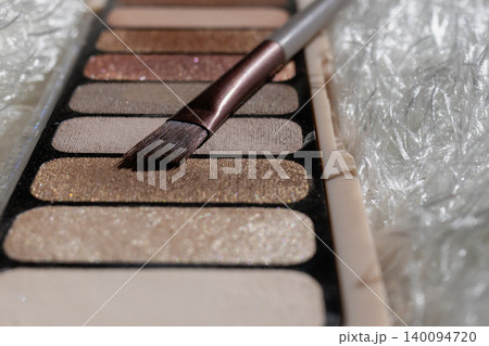 Nude eyeshadow palette showing various shimmer and matte shades. Including glitter and brown tones. Beauty products and cosmetics concepts Nude eyeshadow palette showing various shimmer and matte shades. Including glitter and brown tones. Beauty products and cosmetics concepts 140094720