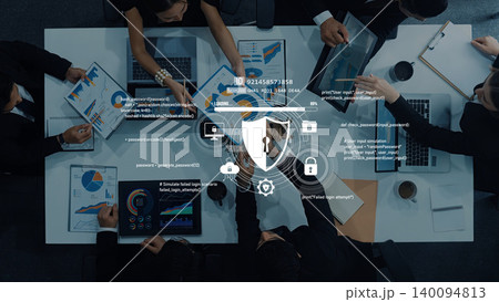 Business Team Collaboration on Data Analysis and Cybersecurity with Digital Lock Icon Overlaid on Table with Charts and Laptops Trope Business Team Collaboration on Data Analysis and Cybersecurity with Digital Lock Icon Overlaid on Table with Charts and Laptops Trope 140094813