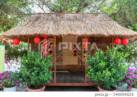 Traditional Vietnamese bamboo hut with thatched roof decorated with red lanterns at Linh Ung Pagoda on Son Tra Peninsula 140094828