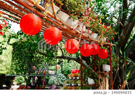 Row of red round paper lanterns hanging on a bamboo frame with flower pots at Linh Ung Pagoda on Son Tra Peninsula in Da Nang Vietnam 140094835