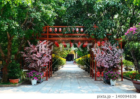 Decorative red metal archway alley with hanging lanterns and artificial pink blossom trees at Linh Ung Pagoda on Son Tra Peninsula in Da Nang Vietnam Decorative red metal archway alley with hanging lanterns and artificial pink blossom trees at Linh Ung Pagoda on Son Tra Peninsula in Da Nang Vietnam 140094836