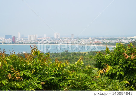 Panoramic city view of Da Nang with sandy beach and traditional fishing boats in the ocean bay look from Son Tra Peninsula in Quang Nam Vietnam Panoramic city view of Da Nang with sandy beach and traditional fishing boats in the ocean bay look from Son Tra Peninsula in Quang Nam Vietnam 140094843