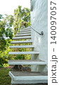Minimalist white concrete cantilever staircase on a curved white wall 140097057