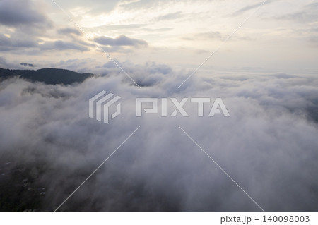 Landscape of Morning Mist with Mountain Layer. mountain ridge and clouds in rural jungle bush forest Landscape of Morning Mist with Mountain Layer. mountain ridge and clouds in rural jungle bush forest 140098003