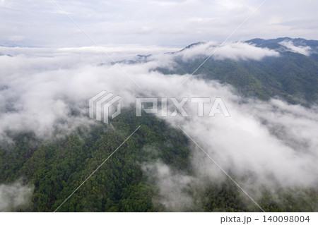Landscape of Morning Mist with Mountain Layer. mountain ridge and clouds in rural jungle bush forest Landscape of Morning Mist with Mountain Layer. mountain ridge and clouds in rural jungle bush forest 140098004