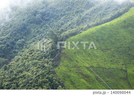 Landscape of Morning Mist with Mountain Layer. mountain ridge and clouds in rural jungle bush forest 140098044