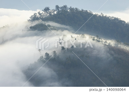 Landscape of Morning Mist with Mountain Layer. mountain ridge and clouds in rural jungle bush forest Landscape of Morning Mist with Mountain Layer. mountain ridge and clouds in rural jungle bush forest 140098064