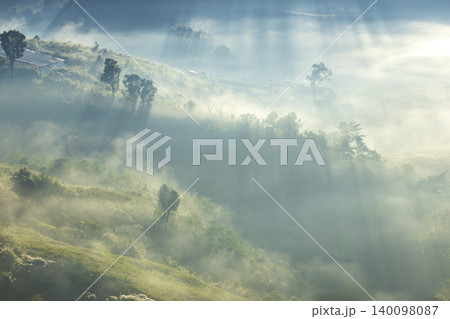 Landscape of Morning Mist with Mountain Layer. mountain ridge and clouds in rural jungle bush forest Landscape of Morning Mist with Mountain Layer. mountain ridge and clouds in rural jungle bush forest 140098087