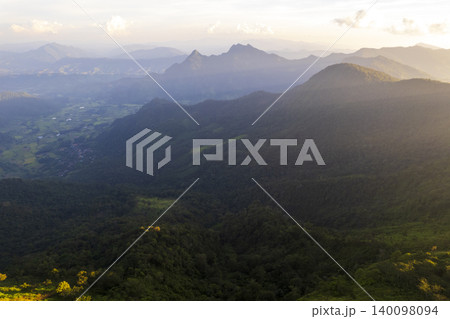 Landscape of Morning Mist with Mountain Layer. mountain ridge and clouds in rural jungle bush forest Landscape of Morning Mist with Mountain Layer. mountain ridge and clouds in rural jungle bush forest 140098094