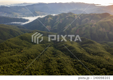 Landscape of Morning Mist with Mountain Layer. mountain ridge and clouds in rural jungle bush forest Landscape of Morning Mist with Mountain Layer. mountain ridge and clouds in rural jungle bush forest 140098101