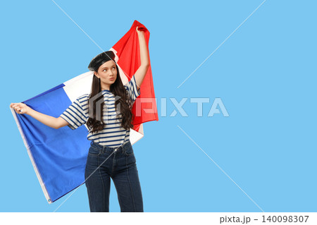 Young woman waves French flag. Celebration of travel and cultural exploration concept Young woman waves French flag. Celebration of travel and cultural exploration concept 140098307