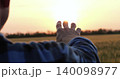 man hand close up stretched to sunset sky during countryside travel. silhouette of male hand at sunset in sunbeams, unity of traveler with nature in countryside 140098977