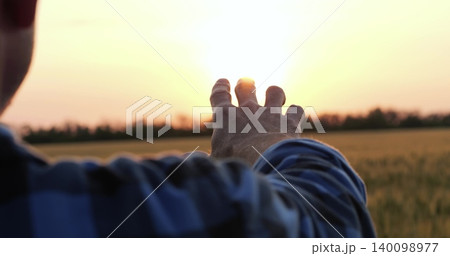 man hand close up stretched to sunset sky during countryside travel. silhouette of male hand at sunset in sunbeams, unity of traveler with nature in countryside man hand close up stretched to sunset sky during countryside travel. silhouette of male hand at sunset in sunbeams, unity of traveler with nature in countryside 140098977