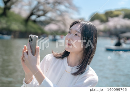 千鳥ヶ淵のボートで花見を楽しむ若い女性 スマホで自撮り 観光 デート 140099766