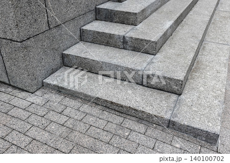 Abstract photo of granite steps highlighting sharp geometric lines, rough stone texture 140100702