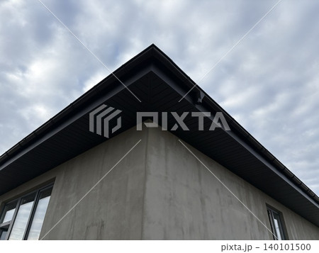 the sharp corner of a modern building, likely under construction or renovation. the sharp corner of a modern building, likely under construction or renovation. 140101500