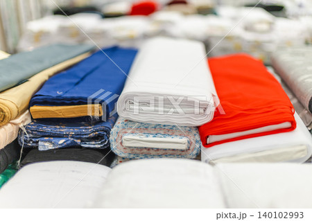 Colorful folded fabric and textile materials displayed in home improvement store Colorful folded fabric and textile materials displayed in home improvement store 140102993