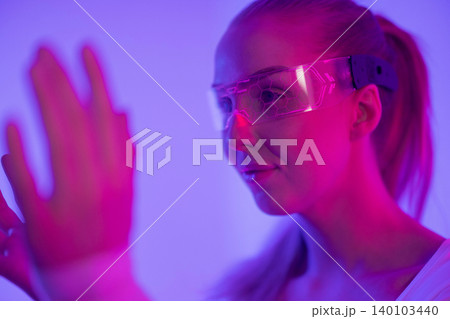 Woman Interacting with Futuristic Technology 140103440