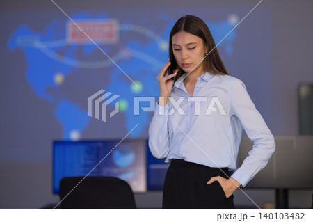 Focused analyst in SOC monitoring global cybersecurity threats on digital dashboards Focused analyst in SOC monitoring global cybersecurity threats on digital dashboards 140103482