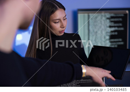 Team discussing cybersecurity issues in a modern SOC environment Team discussing cybersecurity issues in a modern SOC environment 140103485