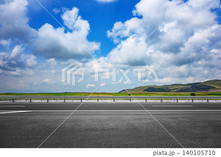 Open road under vibrant sky with no people or vehicles 140105710
