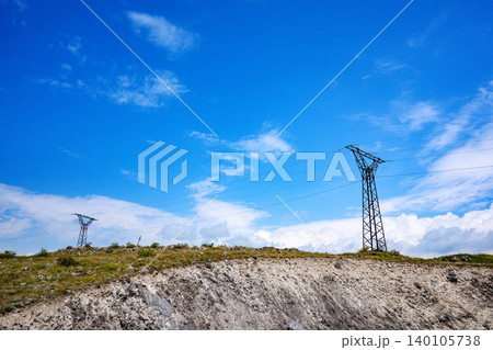 Power lines and towers rise above a barren Power lines and towers rise above a barren 140105738