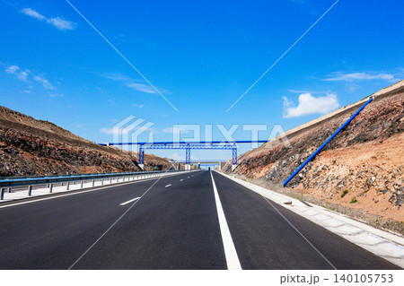 Clear blue sky with scattered clouds above 140105753