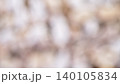 Blurred background shows colors and shapes that suggest a natural setting in an outdoor environment 140105834
