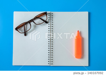 Top view of open student notebook and color marker pen. Top view of open student notebook and color marker pen. 140107092