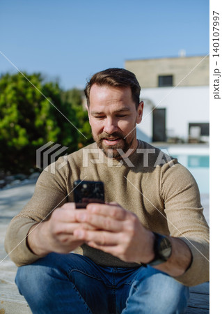 Man enjoying warm spring sunlight on face while standing outside. Man enjoying warm spring sunlight on face while standing outside. 140107997