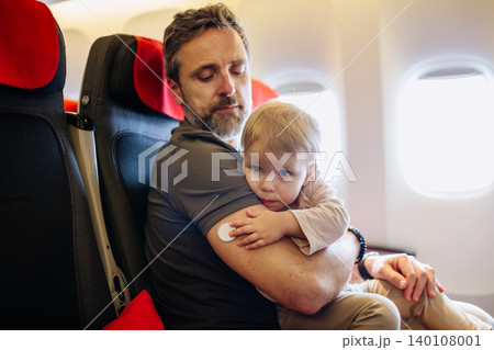 Diabetic father takign care of toddler during family flight. Diabetic father takign care of toddler during family flight. 140108001