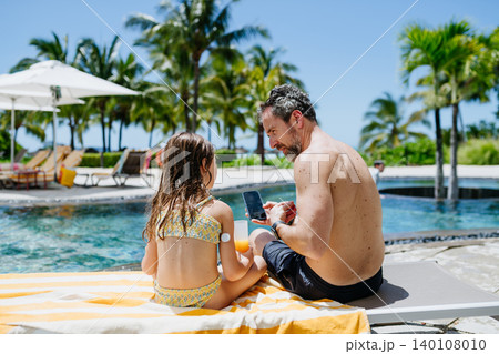 Father checking girls glucose level during family vacation. Father checking girls glucose level during family vacation. 140108010
