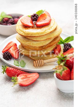 Stack of pancakes with berries, honey, and mint Stack of pancakes with berries, honey, and mint 140108868