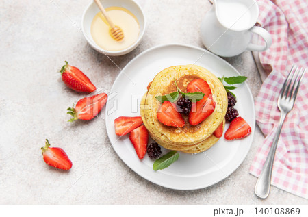 Stacked pancakes with fresh berries and honey 140108869